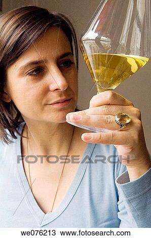 Lady looking at glass of white wine View Large Photo Image Stock Image - Lady looking at glass of white wine. Fotosearch