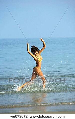 Latin girl playing on the beach View Large Photo Image Stock Image - Latin girl playing on the beach. Fotosearch
