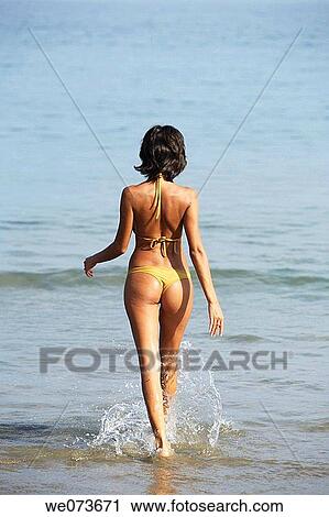Latin girl walking on the beach View Large Photo Image Stock Image - Latin girl walking on the beach. Fotosearch