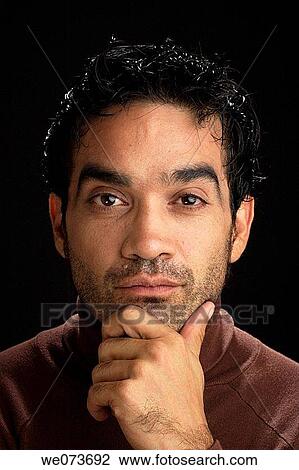 Latin man looking thoughtful at the camera in studio View Large Photo Image Stock Image - Latin man looking thoughtful at the camera in studio. Fotosearch