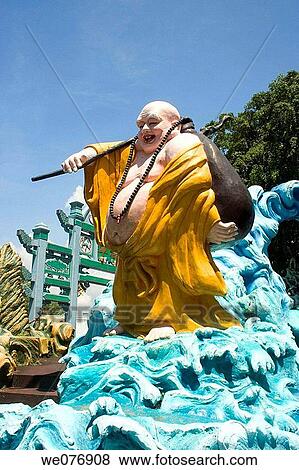 Stock Photo - Laughing Buddha in Haw Par gardens, Singapore. Fotosearch