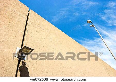 Light on a building's exterior next to a streetlamp. View Large Photo Image Stock Photograph - Light on a building's exterior next to a streetlamp.. Fotosearch