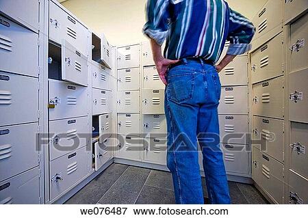 Man standing in front of students? lockers at a college. View Large Photo Image Stock Photo - Man standing in front of students? lockers at a college.. Fotosearch