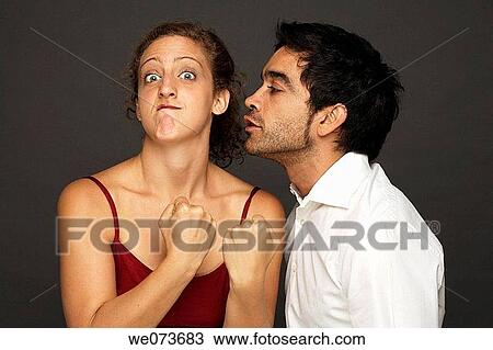 Man tries to kiss woman while she reacts in fight mode View Large Photo Image Stock Image - Man tries to kiss woman while she reacts in fight mode. Fotosearch