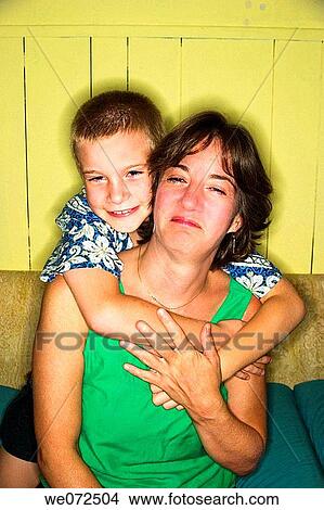 Picture - Middle age woman clowning with her young son. Fotosearch