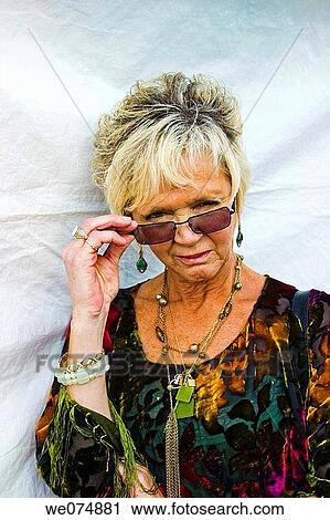 Middle age woman, wearing sunglasses, posing at a fair in Connecticut, USA. View Large Photo Image Stock Image - Middle age woman, wearing sunglasses, posing at a fair in Connecticut, USA.. Fotosearch