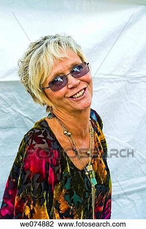 Middle age woman, wearing sunglasses, posing at a fair in Connecticut, USA. View Large Photo Image Stock Image - Middle age woman, wearing sunglasses, posing at a fair in Connecticut, USA.. Fotosearch