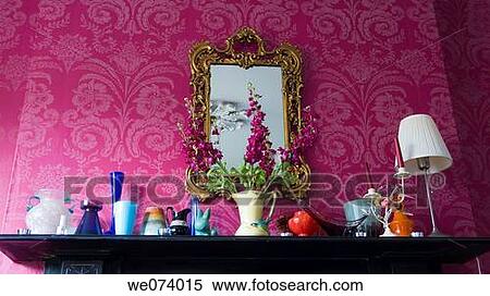 Stock Photography - Mirror and assorted vases on mantlepiece. Fotosearch