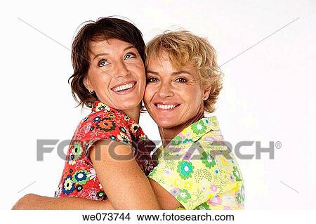 Mother and daughter hug in a studio setting View Large Photo Image Picture - Mother and daughter hug in a studio setting. Fotosearch