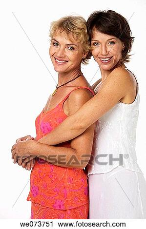 Mother and daughter hug in a studio setting View Large Photo Image Stock Image - Mother and daughter hug in a studio setting. Fotosearch