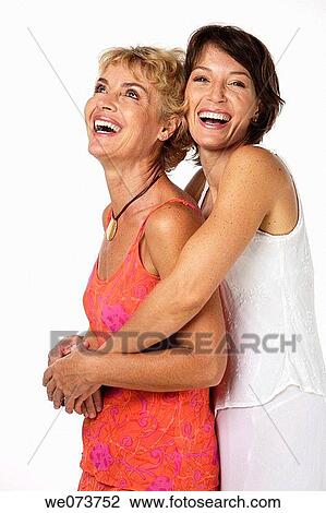 Stock Image - Mother and daughter hug in a studio setting. Fotosearch