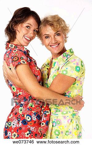 Mother and daughter hug in a studio setting View Large Photo Image Stock Photograph - Mother and daughter hug in a studio setting. Fotosearch