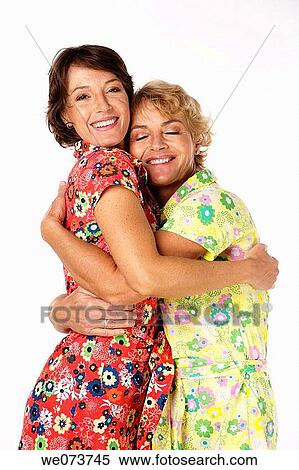 Mother and daughter hug in a studio setting View Large Photo Image Stock Photography - Mother and daughter hug in a studio setting. Fotosearch