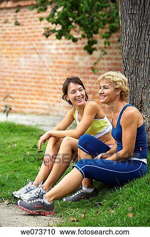 Mother and daughter resting after exercise View Large Photo Image Stock Image - Mother and daughter resting after exercise. Fotosearch