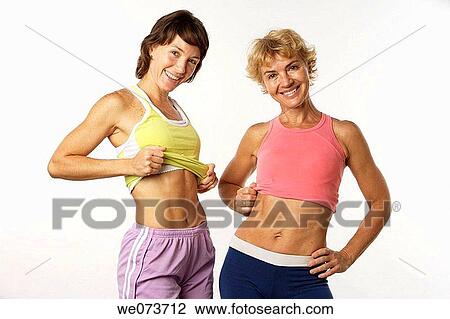 Mother and daughter show their flat stomachs View Large Photo Image Stock Image - Mother and daughter show their flat stomachs. Fotosearch