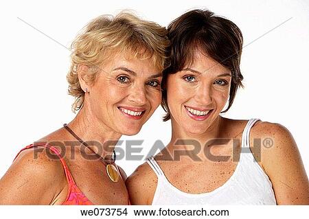 Mother and daughter strike a pose in a studio setting View Large Photo Image Picture - Mother and daughter strike a pose in a studio setting. Fotosearch