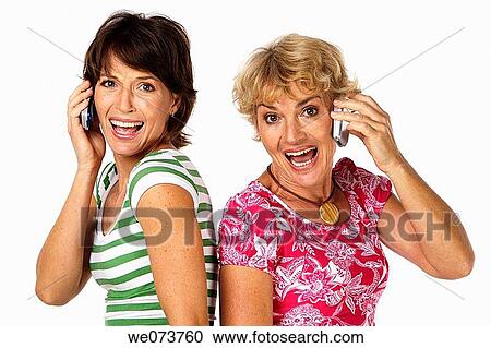 Mother and daughter talk on the phone in a studio setting View Large Photo Image Stock Image - Mother and daughter talk on the phone in a studio setting. Fotosearch