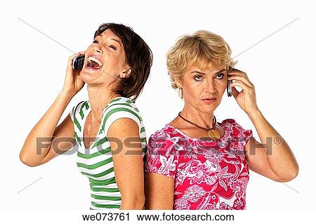 Mother and daughter talk on their phones in a studio setting View Large Photo Image Stock Image - Mother and daughter talk on their phones in a studio setting. Fotosearch