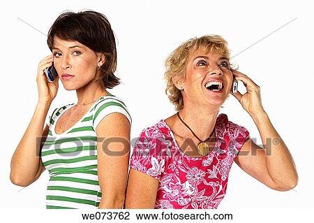 Mother and daughter talk on their phones in a studio setting View Large Photo Image Stock Image - Mother and daughter talk on their phones in a studio setting. Fotosearch