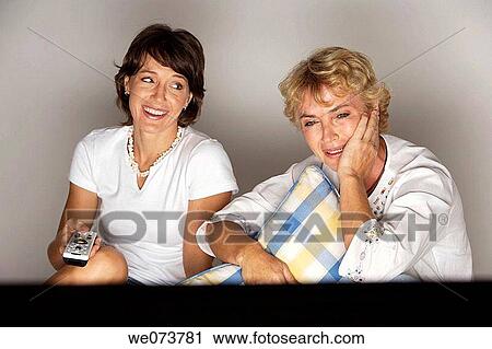 Mother and daughter watching television View Large Photo Image Stock Image - Mother and daughter watching television. Fotosearch