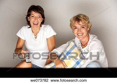 Mother and daughter watching television View Large Photo Image Stock Image - Mother and daughter watching television. Fotosearch