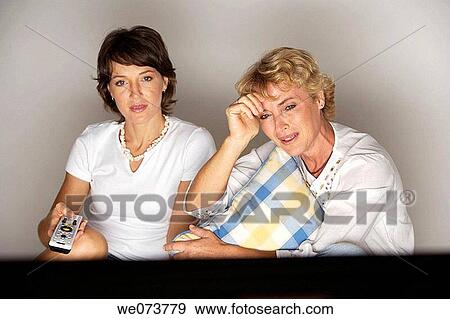 Mother and daughter watching television View Large Photo Image Stock Photo - Mother and daughter watching television. Fotosearch