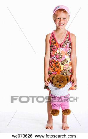 Portrait of a blond girl with a cap and her toy bear View Large Photo Image Stock Photograph - Portrait of a blond girl with a cap and her toy bear. Fotosearch