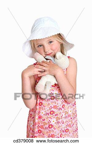 Portrait of a blond girl with a hat and toy animal View Large Photo Image Stock Photo - Portrait of a blond girl with a hat and toy animal. Fotosearch