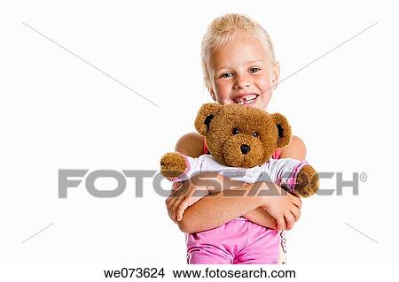 Portrait of a blond girl with her toy bear View Large Photo Image Picture - Portrait of a blond girl with her toy bear. Fotosearch