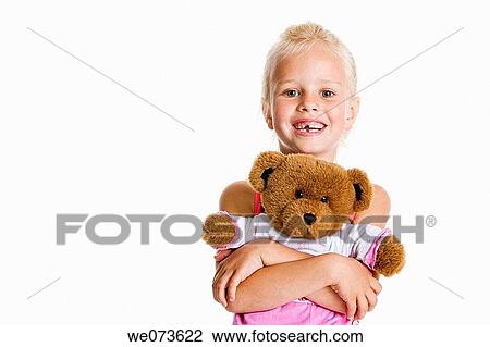 Portrait of a blond girl with her toy bear View Large Photo Image Stock Image - Portrait of a blond girl with her toy bear. Fotosearch