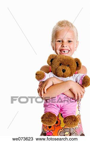 Portrait of a blond girl with her toy bear View Large Photo Image Stock Image - Portrait of a blond girl with her toy bear. Fotosearch