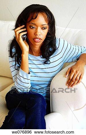 Stock Photograph - Portrait of a upscale woman holding a cell phone. Fotosearch