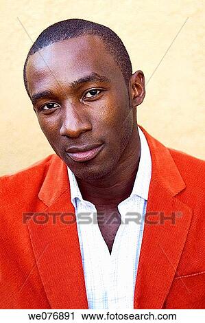 Stock Image - Portrait of man in suit looking at camera. Fotosearch