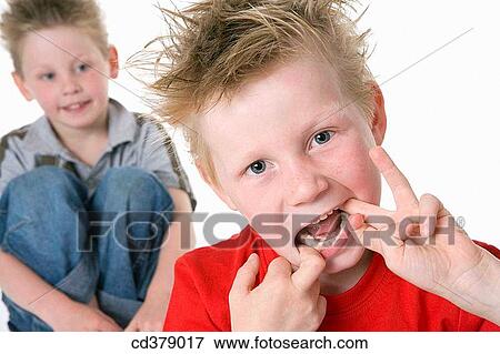 Portrait of two boys with a funny face View Large Photo Image Stock Photo - Portrait of two boys with a funny face. Fotosearch