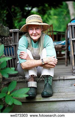 Senior woman with gardening clothes sitting View Large Photo Image Stock Image - Senior woman with gardening clothes sitting. Fotosearch