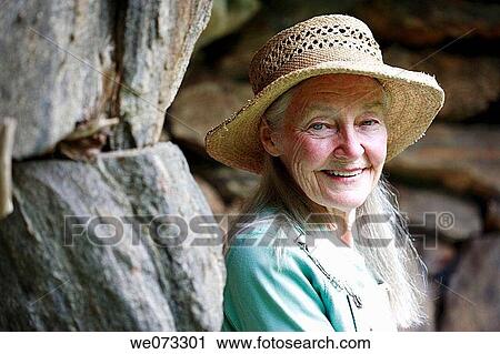 Senior woman with straw hat looking into camera View Large Photo Image Stock Image - Senior woman with straw hat looking into camera. Fotosearch