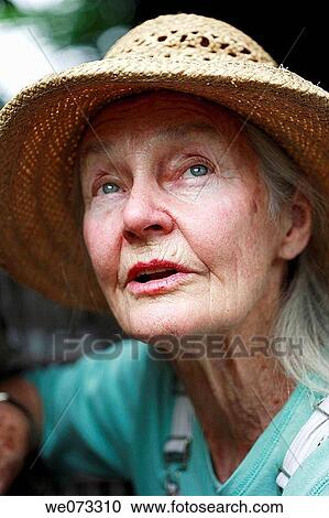 Senior woman with straw hat looking up View Large Photo Image Stock Image - Senior woman with straw hat looking up. Fotosearch