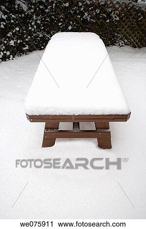 Stock Image - SNOW ON OUTDOOR. PICNIC TABLE. Fotosearch