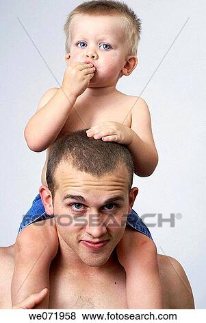 Son riding on his father's shoulders. View Large Photo Image Stock Photo - Son riding on his father's shoulders.. Fotosearch