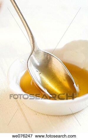 Stock Photo - Spoon with honey. Fotosearch