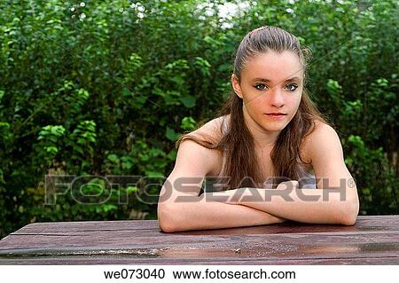Teen girl, sitting at a picnic table, posing for the camera. View Large Photo Image Stock Image - Teen girl, sitting at a picnic table, posing for the camera.. Fotosearch