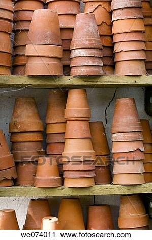 Terracotta pots collected on shelves in potting shed View Large Photo Image Stock Image - Terracotta pots collected on shelves in potting shed. Fotosearch