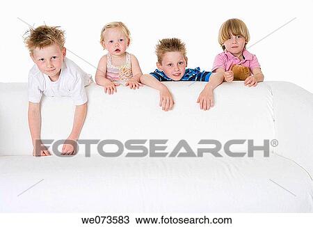 Three boys and a girl looking over a bench View Large Photo Image Stock Image - Three boys and a girl looking over a bench. Fotosearch
