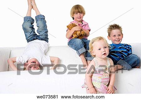 Three boys and a girl making fun on a bench View Large Photo Image Stock Image - Three boys and a girl making fun on a bench. Fotosearch