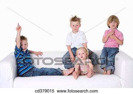 Stock Photography - Three boys and a girl sitting on a bench. Fotosearch