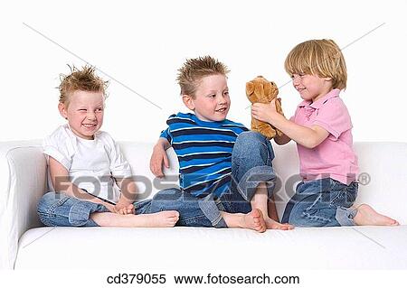 Three boys sitting on a bench View Large Photo Image Stock Photography - Three boys sitting on a bench. Fotosearch
