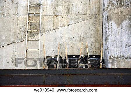 Three wheelbarrows and ladder in a row on a construction site View Large Photo Image Stock Image - Three wheelbarrows and ladder in a row on a construction site. Fotosearch
