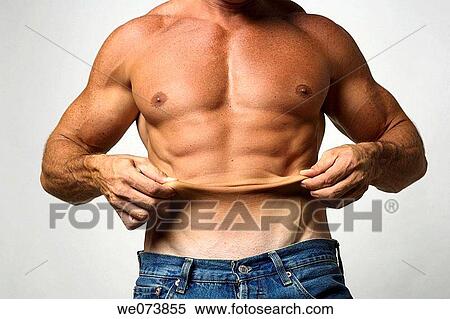 Stock Photography - Tough strong man in his 30s showing excess skin. Fotosearch