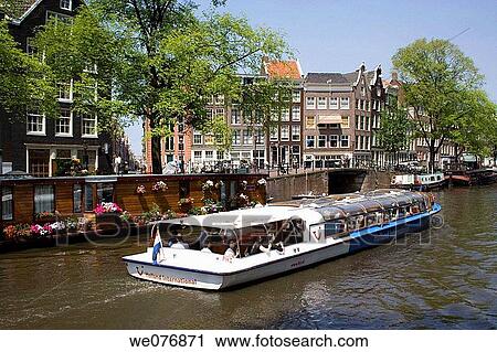 Stock Image - Tour boat on canal, Amsterdam. Holland. Fotosearch