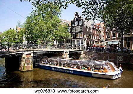 Tour boat on canal, Amsterdam. Holland View Large Photo Image Stock Image - Tour boat on canal, Amsterdam. Holland. Fotosearch